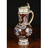 A 17th Century Westerwald Grey Stoneware Jug with incised decoration enhanced with blue & manganese