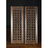 A Pair of 17th Century Fretted Oak Panels carved with repeated designs,