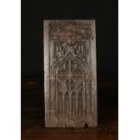 A 15th Century Oak Panel intricately carved with Gothic tracery centred by an arch with trefoil