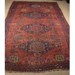 A Large Late 19th Century Soumak Carpet with four red octagons in blue ground diamond medallions on