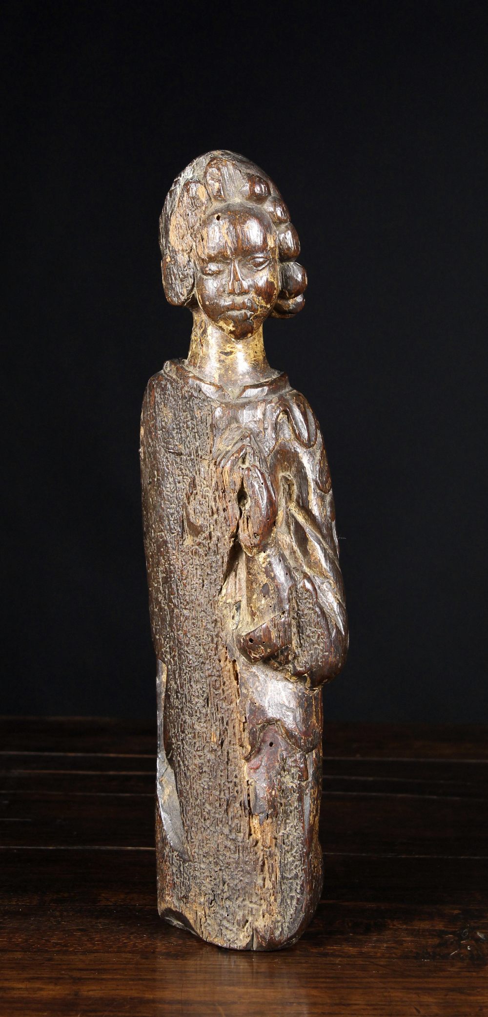A 15th/16th Century Oak Carving of a Kneeling Saint, 17¾ ins (45 cms) in height.