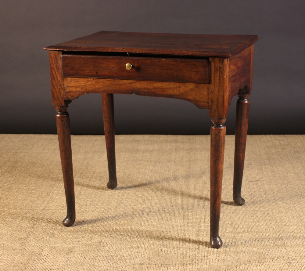 A Small 18th Century Elm Side Table having a single plank top with moulded edge above a frieze
