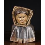 A Carved & Polychromed Gothic Bust of a Monk wearing a hooded cape, 11½ ins (29 cms) in height.