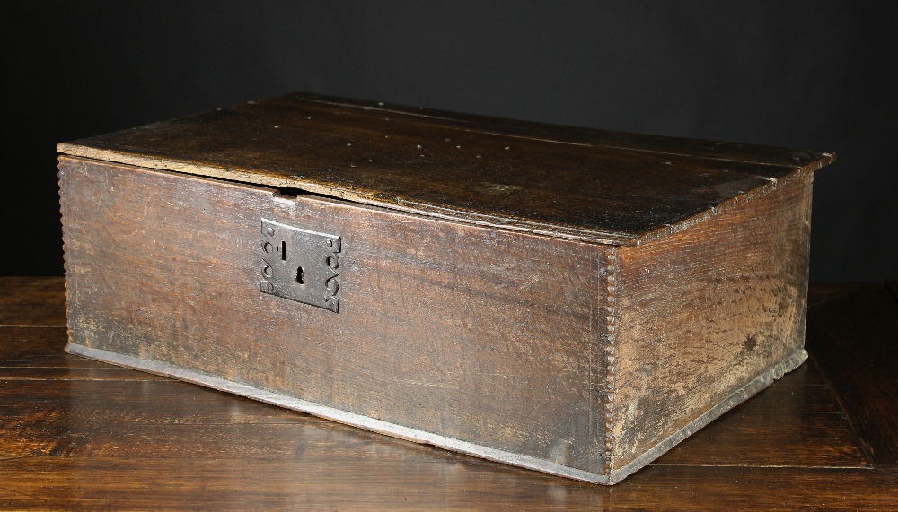 An 18th Century Boarded Oak Box (A/F), 9 ins (23 cms) high, 28 ins x 17 ins (71 cm x 43 cms).