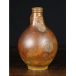 A 17th Century Bellarmine Flagon (A/F) with a bearded face mask above a decorative roundel,