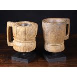 Two Dug Out Treen Mortars with side handles, possibly medieval, one 7 ins (18 cms) high,