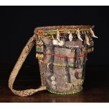 A Dayak Baby Carrier decorated for a display of wealth and prestige of a family and to protect the