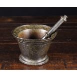 An Early 18th Century Bronze Pestle & Mortar.  The pestle 8 ins (20 cms) long.