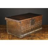 An 18th Century Boarded Oak Box. The lid with engrailed ends on wooden pivots.