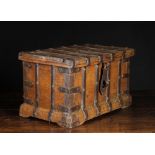 A 17th Century Iron Bound Wooden Box with hasp to the front, standing on a moulded plinth rails,