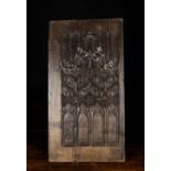 A 16th Century Chestnut Panel finely carved with tracery incorporating Gothic arches & roundel