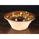 A 19th Century Terracotta Slipware Bowl with dripped yellow slip glaze over a treacle glazed