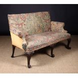 A Fine George II Style Carved Mahogany Settee, upholstered in needlework tapestry.