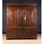 An 18th Century Oak Press Cupboard having two panelled doors opening to reveal hanging space