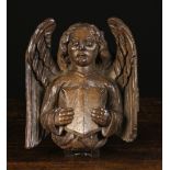 A Fine 15th Century Carved Oak Suffolk Beam Boss in the form of a wavy haired angel bearing a