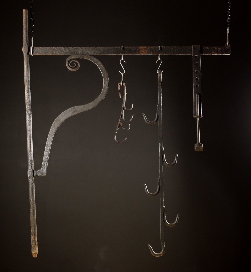 A Large 18th Century Wrought Iron Chimney Crane with one movement 50 ins (127 cms) high,