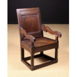 A Mid 17th Century English Joined Oak Wainscot Chair of restrained Puritan design.