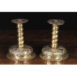 A Pair of Late 17th/Early 18th Century Scandinavian Sheet Brass Candlesticks enriched with repoussé