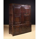 An 18th Century Joined Oak Press Cupboard in two sections.