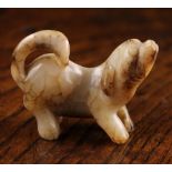 A 19th Century Chinese Jade Carving of a Dog, 2 ins (5 cms) high, 2½ ins (6.5 cms) in length.