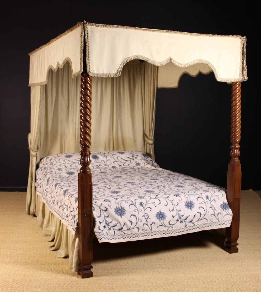 A William IV Style Four Poster Bed: The mahogany foot posts adorned with spiraling reeds and carved