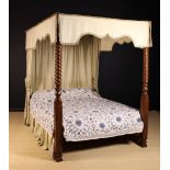 A William IV Style Four Poster Bed: The mahogany foot posts adorned with spiraling reeds and carved