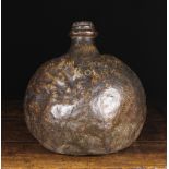 A Large 17th Century Leather Bottle of Globular Form having a wooden stopper and indistinct