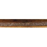 A Long 17th Century Carved Oak Rail decorated with a band of foliate S-scrolls with strap-work