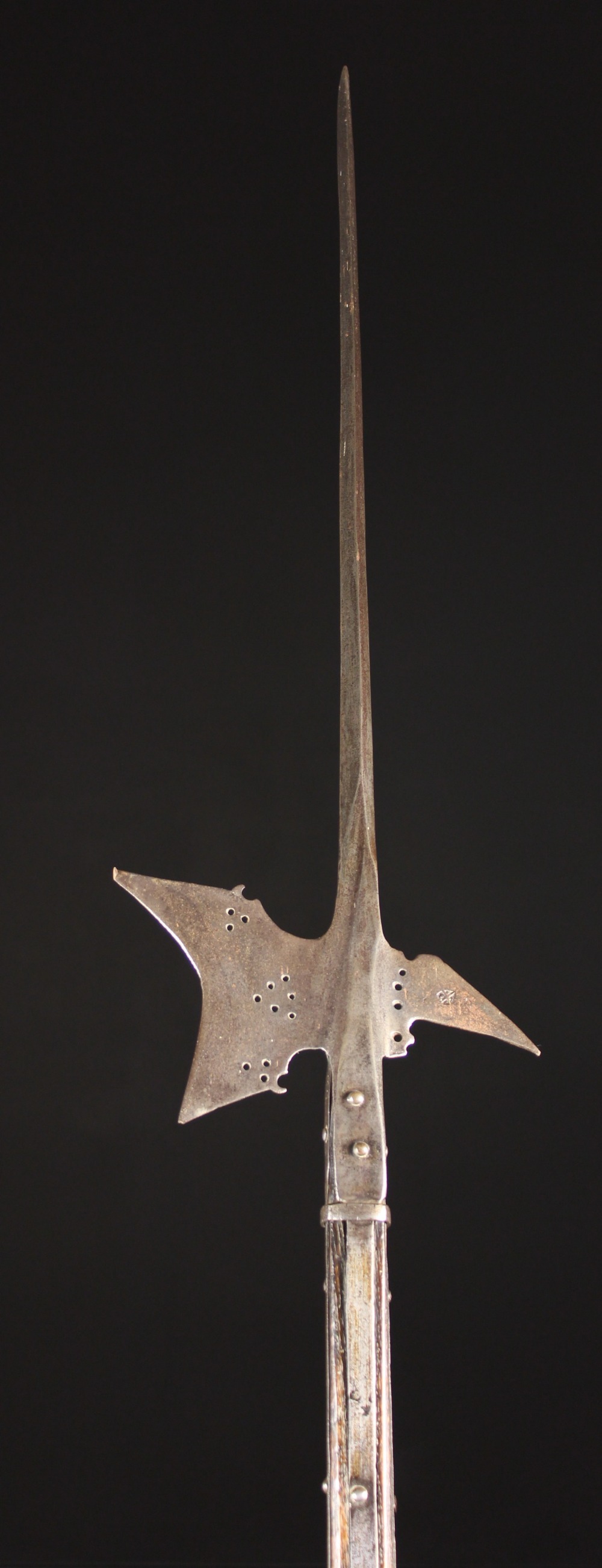 A 17th Century Halberd on a chamfered oak shaft, 75½ ins (192 cms) in length.