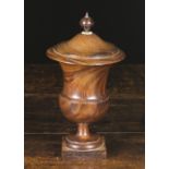 An Early 19th Century Turned Lignum Vitae Treen Campana Urn with cover, 10 ins (25.5 cms) in height.