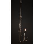 An 18th Century Wrought Iron Pendant Rush Light with height adjustable ratchet support.
