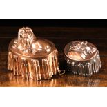 Two 19th Century Copper Jelly Moulds of oval form with elaborately reeded sides: The larger one