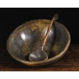 A Large 19th Century Treen Dairy Bowl; probably beechwood, and a dug-out treen ladle with hook end.