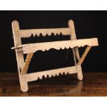 An Antique Pine Wall Hanging Rack roughly constructed from shaped rails nailed together,