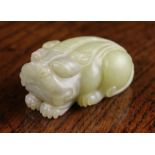 A 19th Century Celadon Jade Carving of a Mythical Beast, 23/8 ins (6 cms) in length,