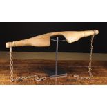 A 19th Century Carved Beechwood Dairymaid's Yoke hung with iron hooks on chains,