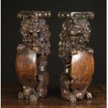 A Pair of Splendid 16th Century Oak Figural Supports carved in the form of Heraldic Lions Sejant