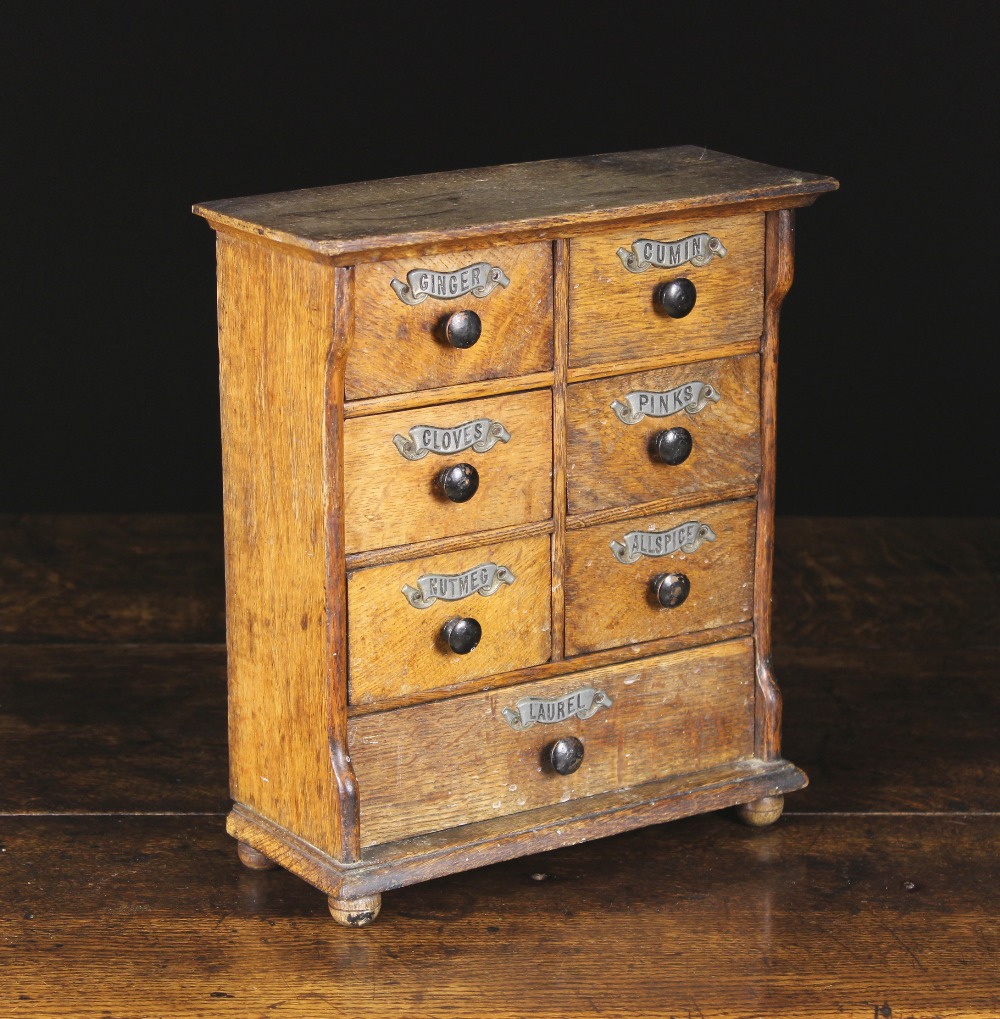 A Late 19th Century Oak Spice Cabinet fitted with six small drawers set in pairs above a long