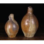 Two 18th Century Salt Glazed Stoneware Flagons, 14 ins (36 cms) and 11 ins (28 cms) in height.