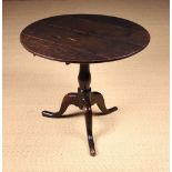A George III English Oak Tripod Table of rich colour and patination.