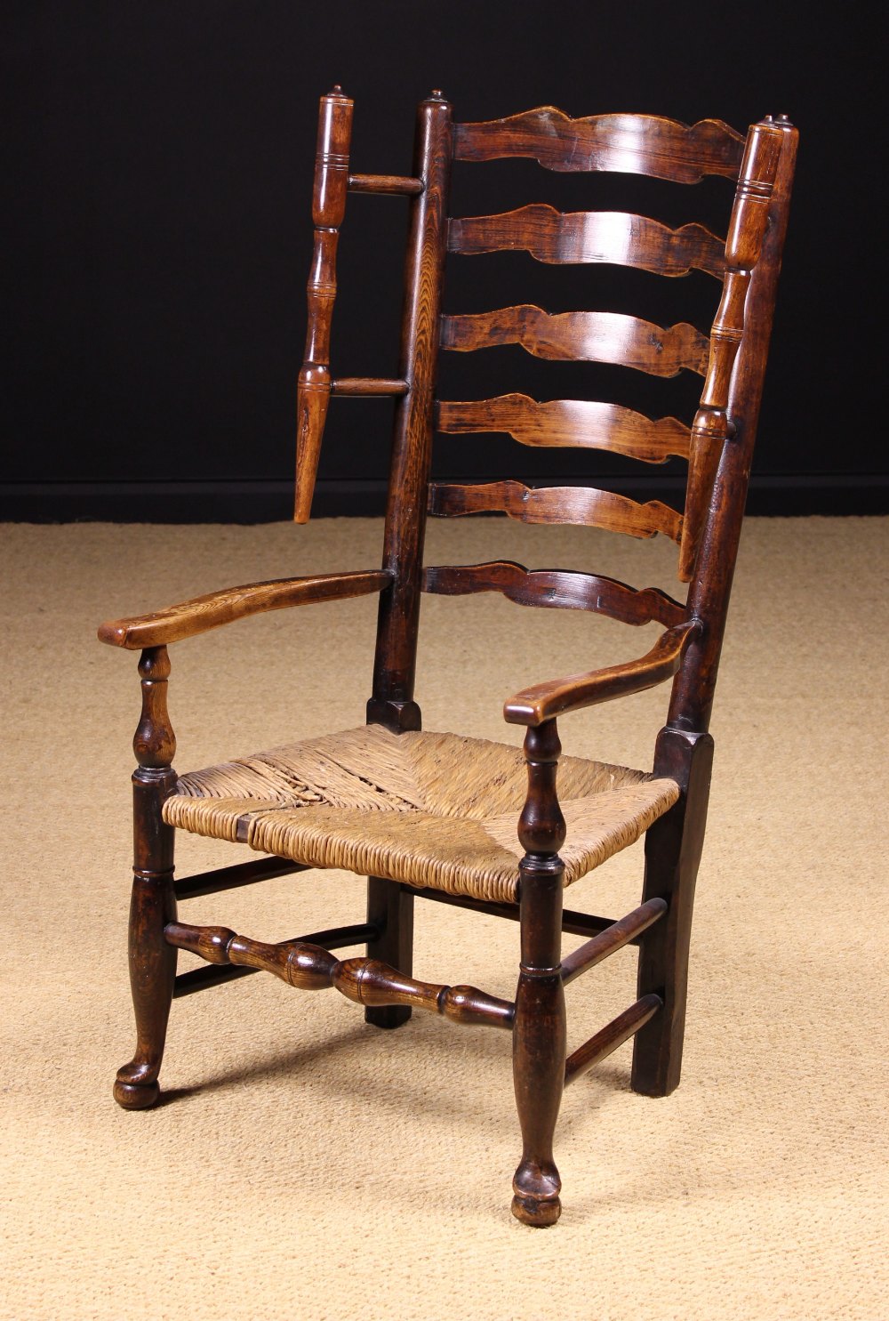 A Fine Late 18th/Early 19th Century Lancashire Wavy Ladder-back Winged Armchair with rush seat.