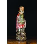 A Late 13th Century Polychromed Carving of Saint Anthony stood with a demon at his feet,