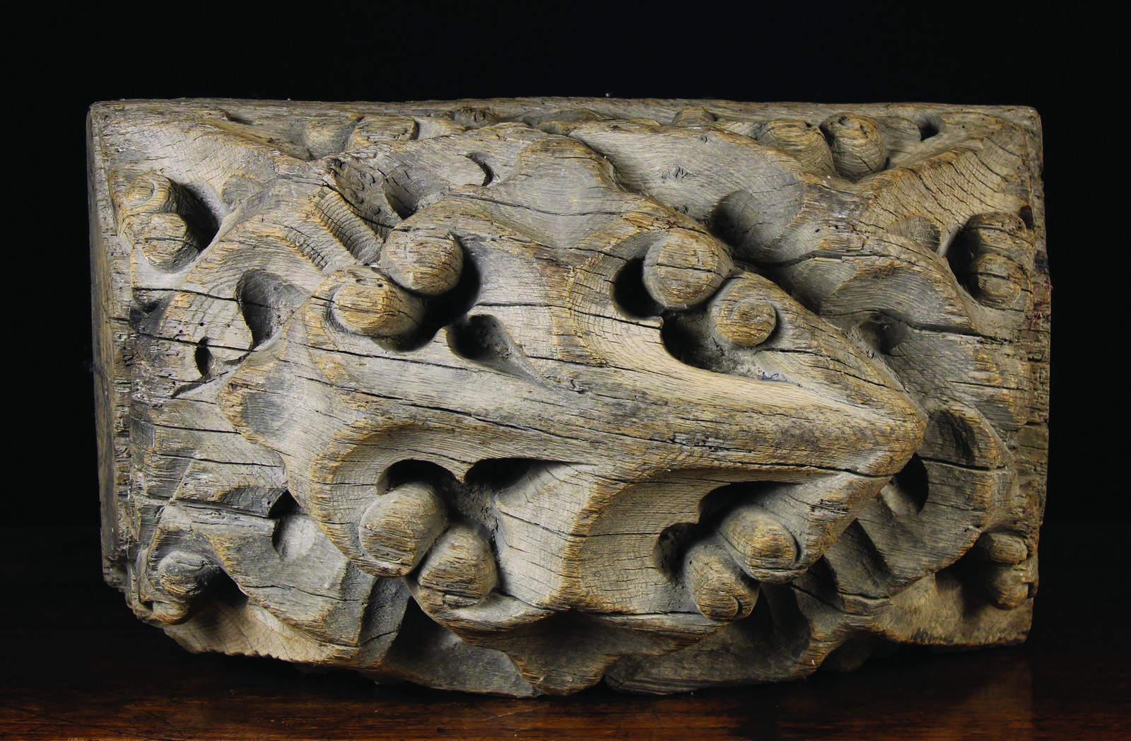 A Large Early 16th Century Oak Ceiling Boss carved with scrolls of Gothic style foliage,