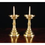 A Pair of 16th Century Flemish Brass Pricket Candlesticks with blade knopped stems on stepped