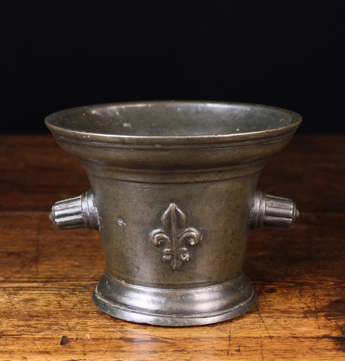 A 17th Century French Bronze Mortar with reeded protuberant handles either side, 5 ins (12.