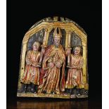 A 17th Century Polychromed Bas Relief Carving depicting a Bishop flanked by acolytes holding