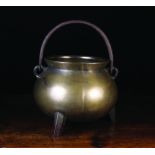 A Large 17th/18th Century Bronze Cauldron with wrought iron swing handle,