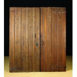 Two 15th Century Oak Doors carved with linen-fold moulding and pierced with later perforations.