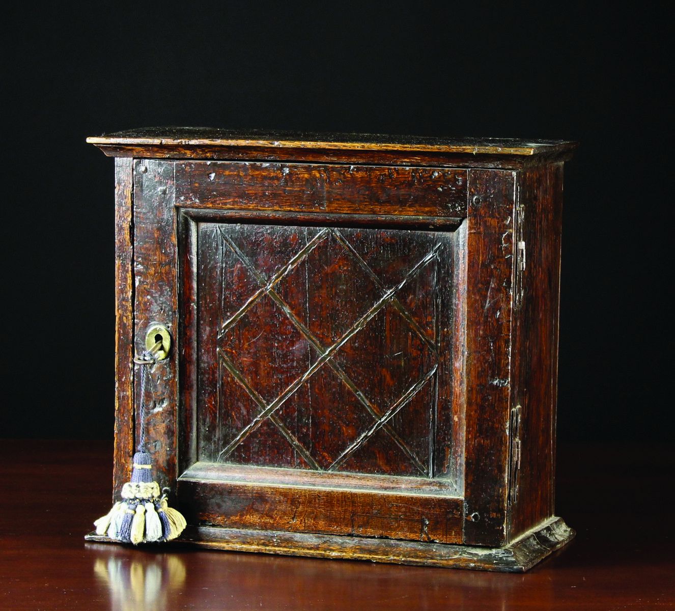 An Early 18th Century Oak Spice Cabinet.