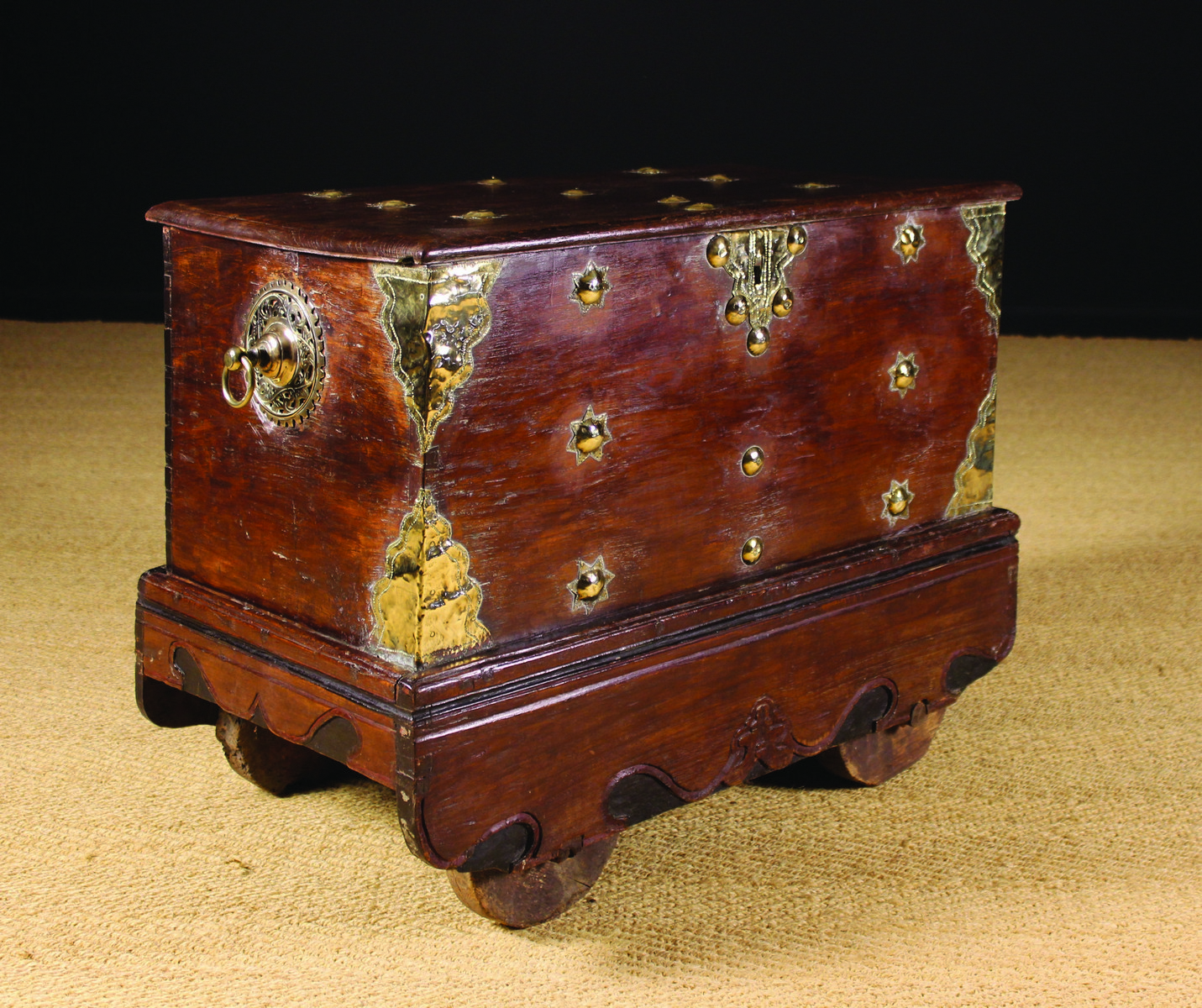 A 19th Century Dutch Colonial Chest on Wheels with decorative brass appliqués.